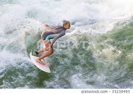 Atractive sporty girl surfing on famous artificial 33230493