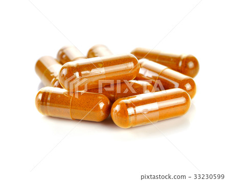 Pill.Tumeric powder capsules on white background. Pill.Tumeric powder capsules on white background. 33230599