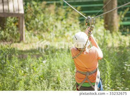 Boy climbs a tree Boy climbs a tree 33232675