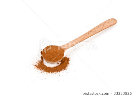ground cinnamon in wooden spoon ground cinnamon in wooden spoon 33233826