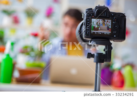 Man florist gardener vlogger blogger shooting 33234291