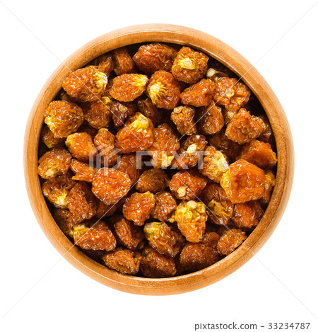Physalis fruits, dried, in wooden bowl over white 33234787
