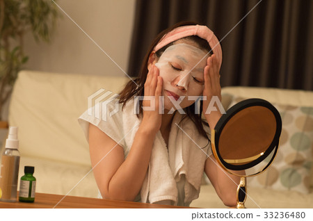 Woman doing facial pack Woman doing facial pack 33236480