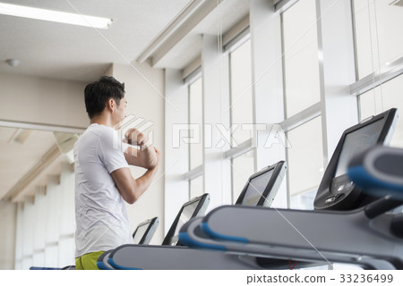 Men starting a running machine 33236499