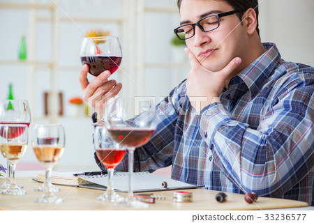 Professional sommelier tasting red wine Professional sommelier tasting red wine 33236577