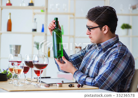 Professional sommelier tasting red wine Professional sommelier tasting red wine 33236578