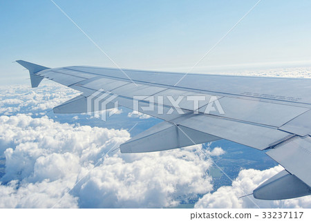 Clouds under the wing of an airplane Clouds under the wing of an airplane 33237117