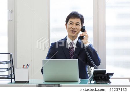 Businessman middle desk office phone 33237185