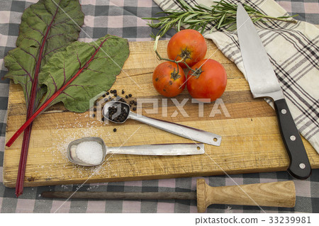 knife and cutting board with fresh vegetables meal 33239981