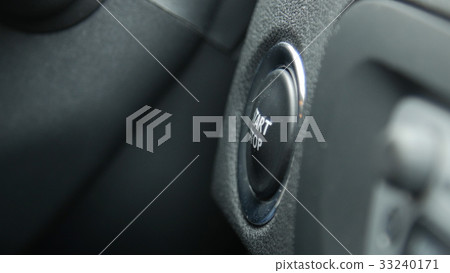 Macro engine start and stop button of a car. Macro engine start and stop button of a car. 33240171