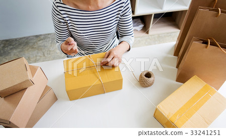 Business owner woman working online shopping prepare product pac 33241251