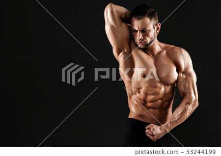 Handsome male model posing at studio. 33244199