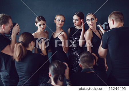 Photographers paparazzi take photos of women in 33244493