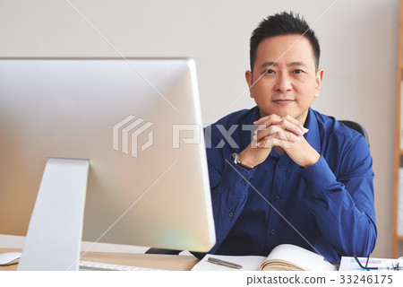 Businessman at table Businessman at table 33246175