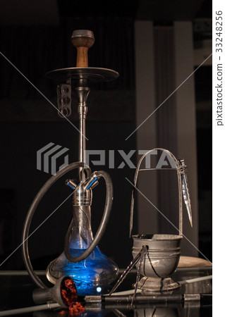 Blue hookah together wit its accessories placed on 33248256