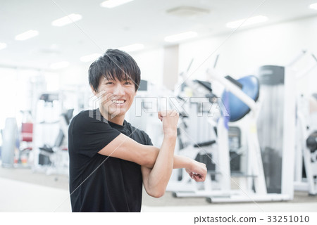 Man stretching, looking at camera 33251010