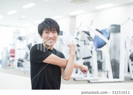 Man stretching, looking at camera 33251011