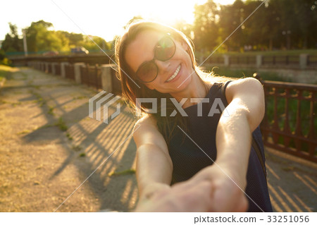 Follow me - happy young woman pulling guy's hand - hand in hand Follow me - happy young woman pulling guy's hand - hand in hand 33251056