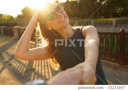 Follow me - happy young woman pulling guy's hand - hand in hand 33251057