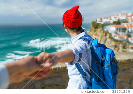 Follow me - happy young woman in a red hat Follow me - happy young woman in a red hat 33251239