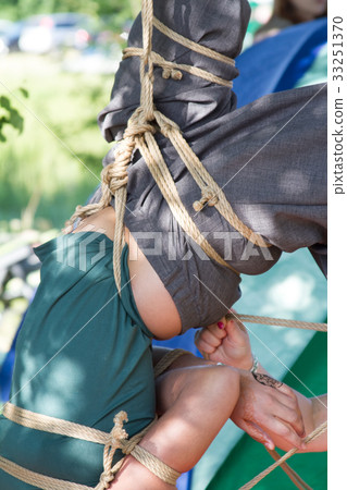 Shibari in nature in summer. Bound young girl. 33251370