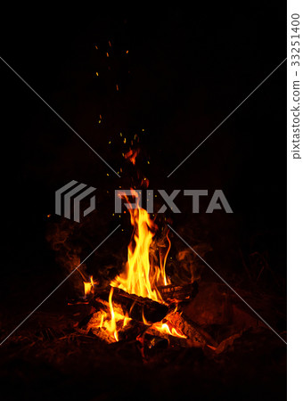 Fire burns at night in a tourist camp 33251400