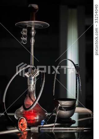The red shisha on a dark background. 33254040
