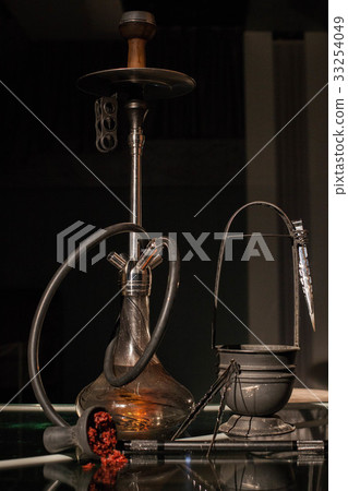 Orange shisha with all accessories placed on the Orange shisha with all accessories placed on the 33254049