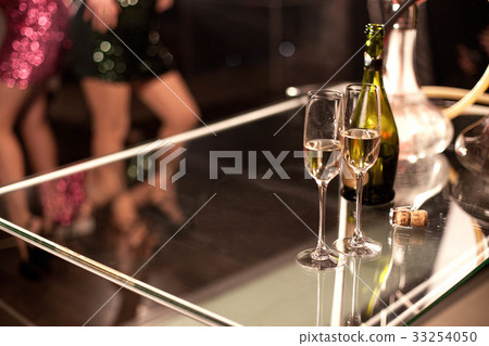Two glasses of wine or champagne placed on a glass Two glasses of wine or champagne placed on a glass 33254050