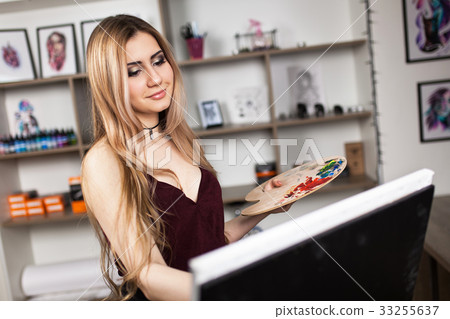 Artist painting in her workshop 33255637