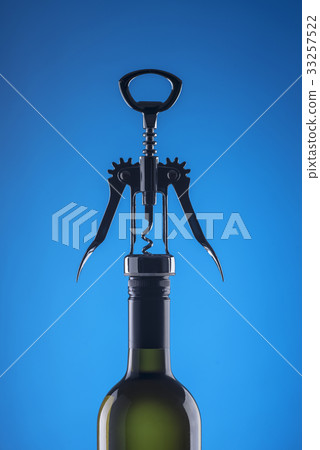 Stylish corkscrew for opening on a blue background Stylish corkscrew for opening on a blue background 33257522