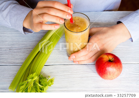 Woman drinking a smoothie of apples and celery 33257709