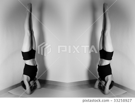 Two women doing yoga position one in front of the other Two women doing yoga position one in front of the other 33258927