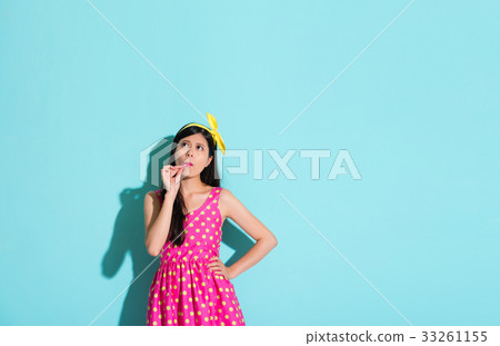 unhappy pretty girl standing in blue background 33261155