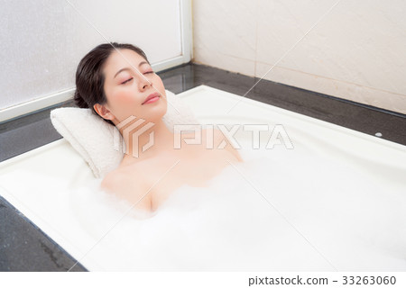 sweet pretty woman lying down in bathtub sleeping 33263060