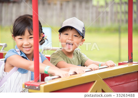 A child riding a vehicle 33263488