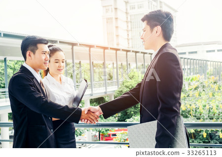 Asian Business Handshake at city outside office Asian Business Handshake at city outside office 33265113