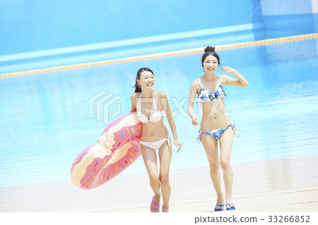 Pool resort bikini woman with floats 33266852