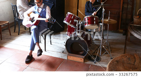 Men playing an instrument 33267575