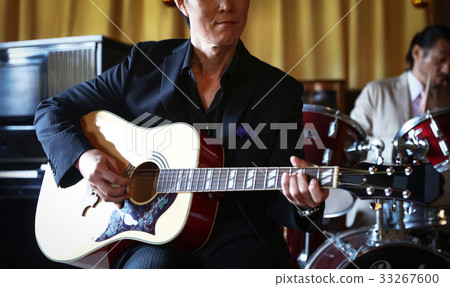 Men playing an instrument 33267600