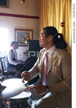 Men playing an instrument 33267625