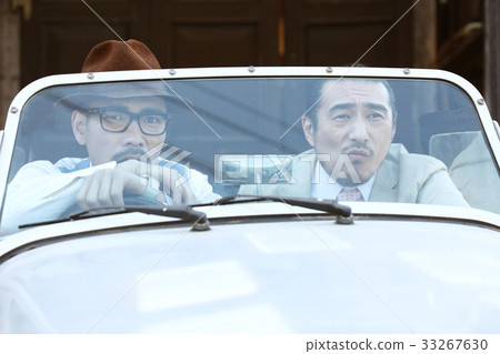 Men riding a car Men riding a car 33267630