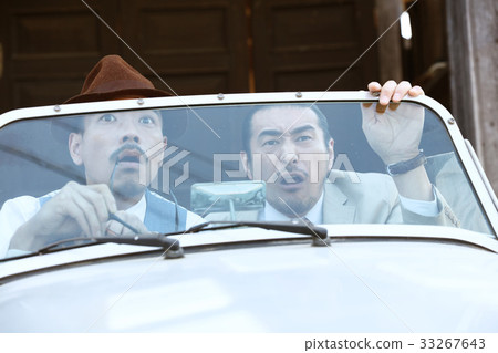 Men riding a car 33267643