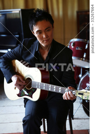 Men playing an instrument 33267664