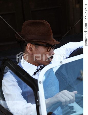 Men riding a car 33267683