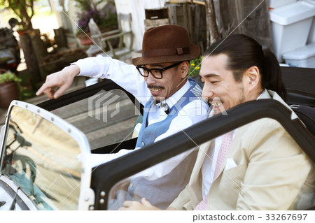 Men riding a car 33267697