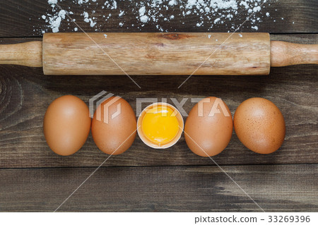 Top view on fresh eggs in a row and rolling pin on Top view on fresh eggs in a row and rolling pin on 33269396