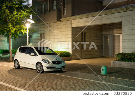 Cityscape at night with white car 33270830