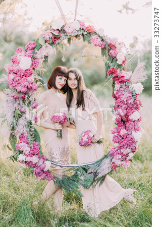 The lovely portrait of the two bridesmaids holding 33273747