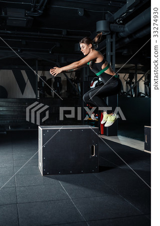 Young woman doing a box jump exercise. 33274930